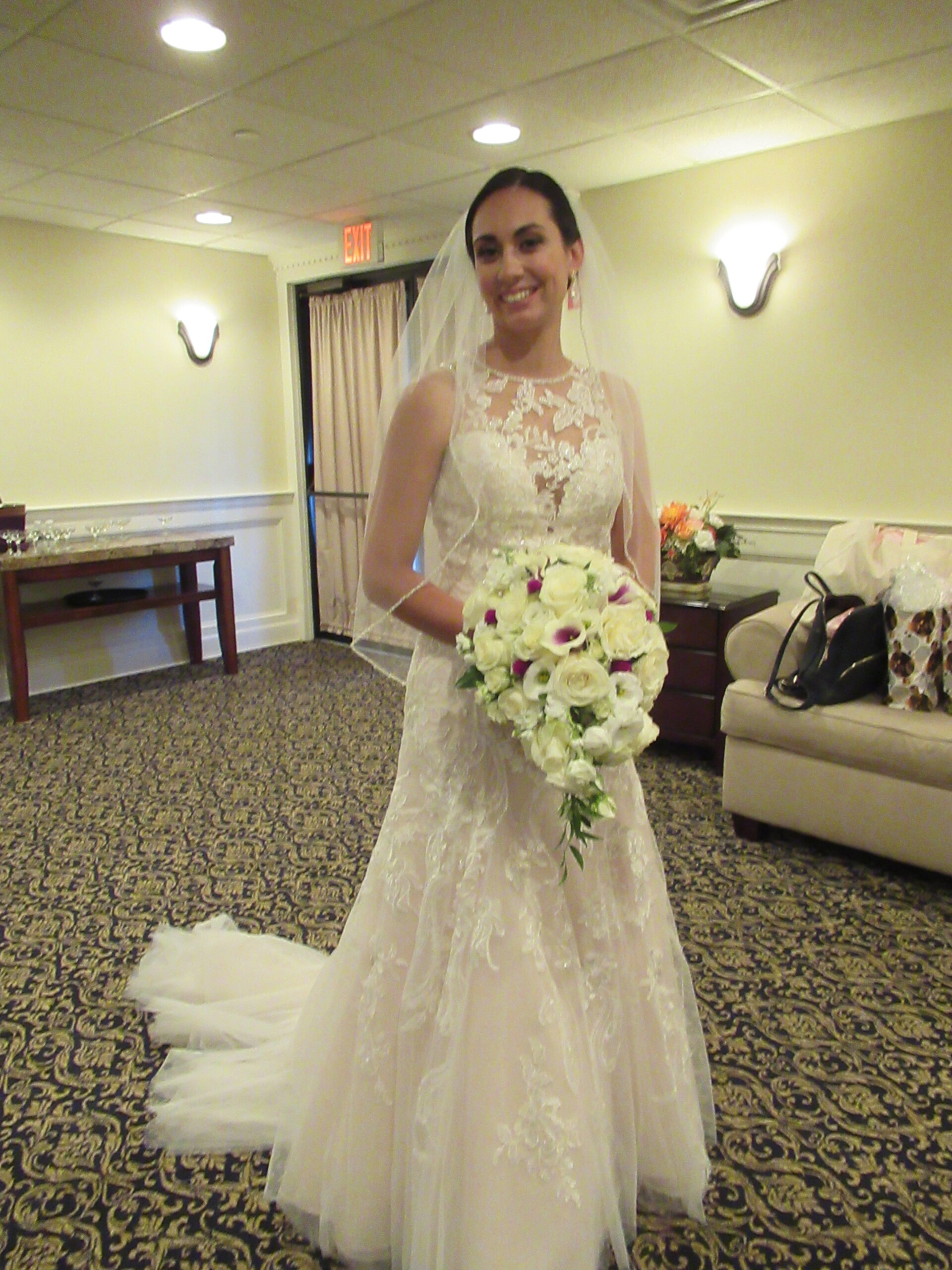 A bride holding a bouquet of white roses