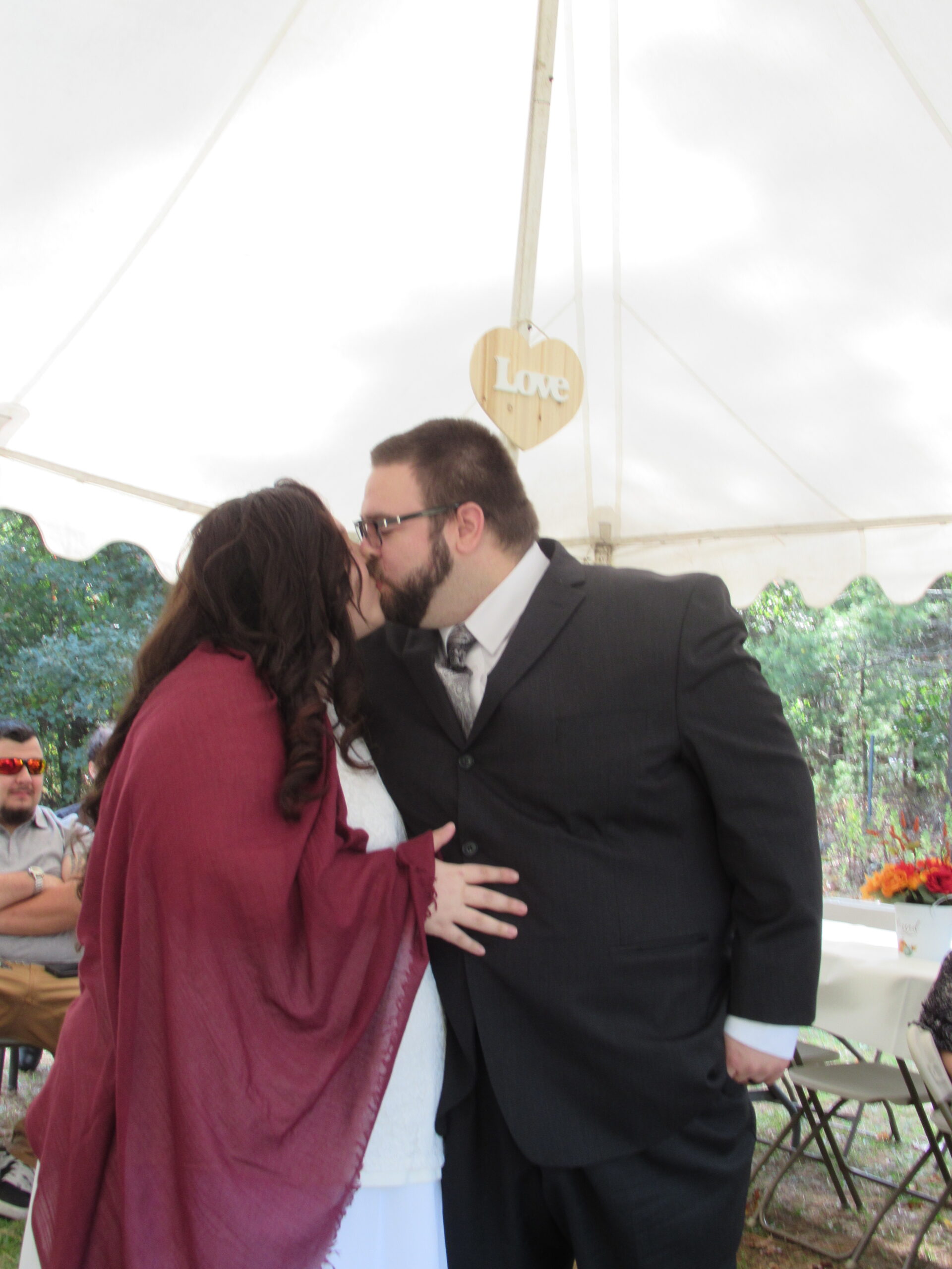 A couple kissing each other on their wedding day